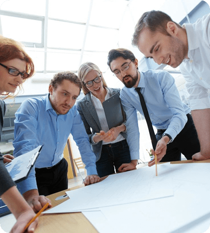 A group of people standing around a table.