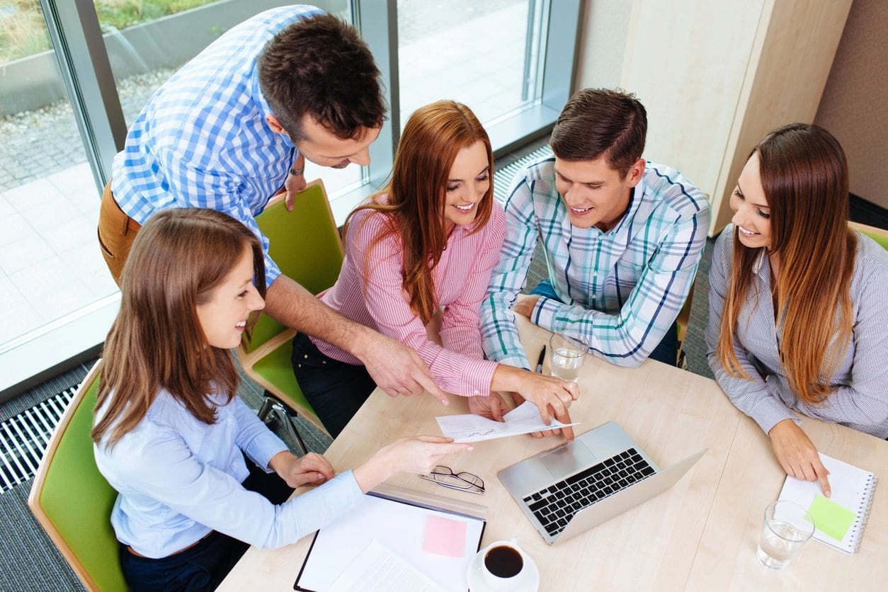 A group of people sitting around a table.